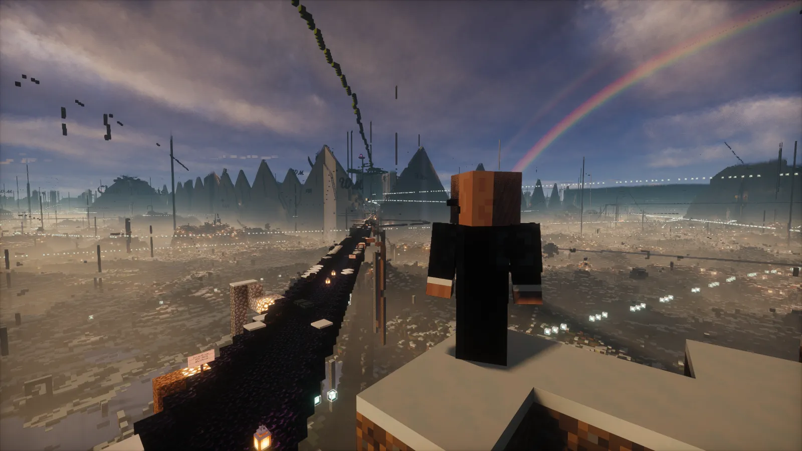 A player looking down an obsidian highway toward a skyline of pyramids and ruins at spawn, with a rainbow overhead