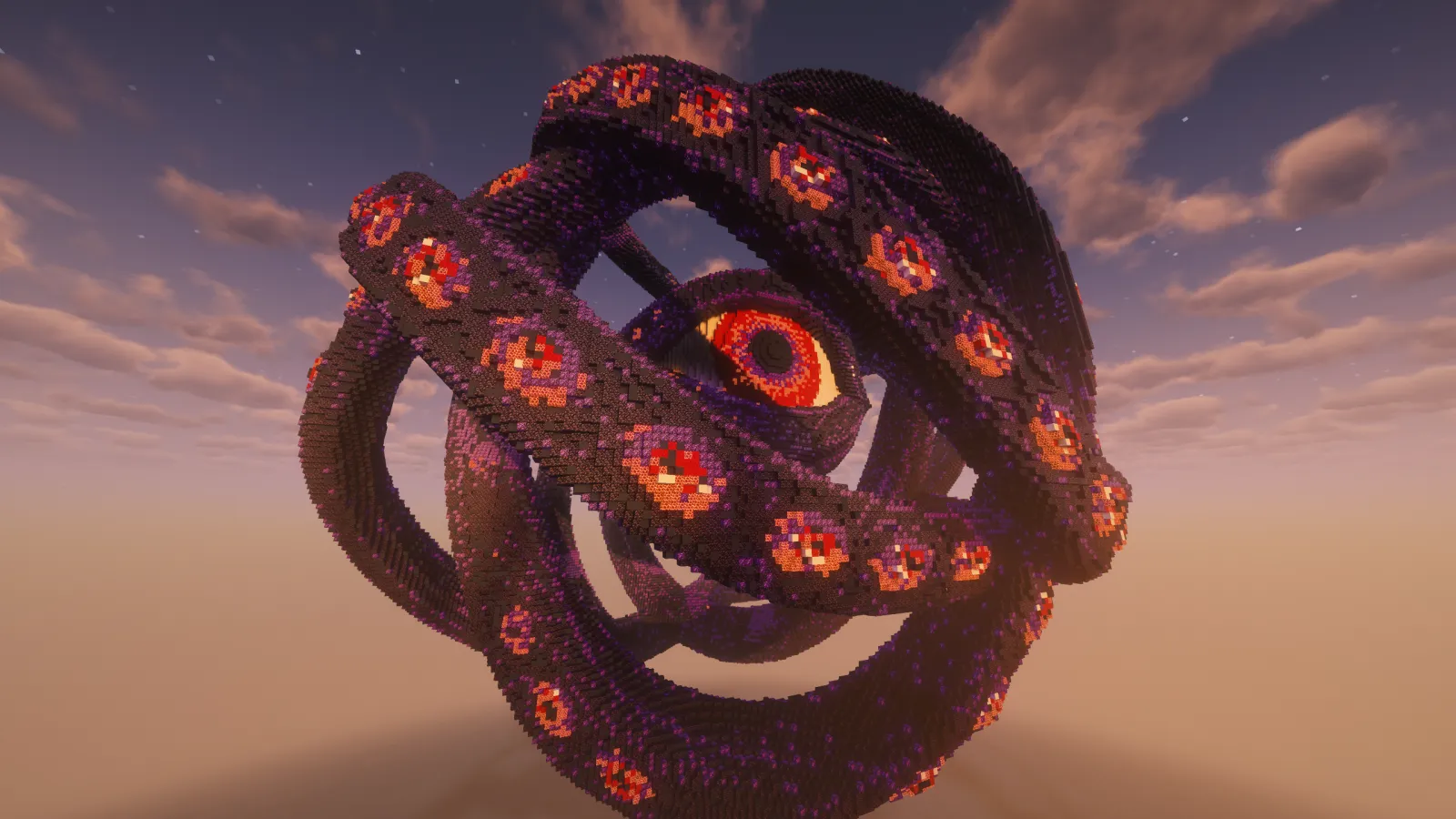 A huge sculpture of twisting purple tentacles covered in red eyes, wrapped around one giant eye, against a dusk sky
